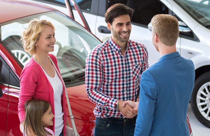 salesperson giving keys to family